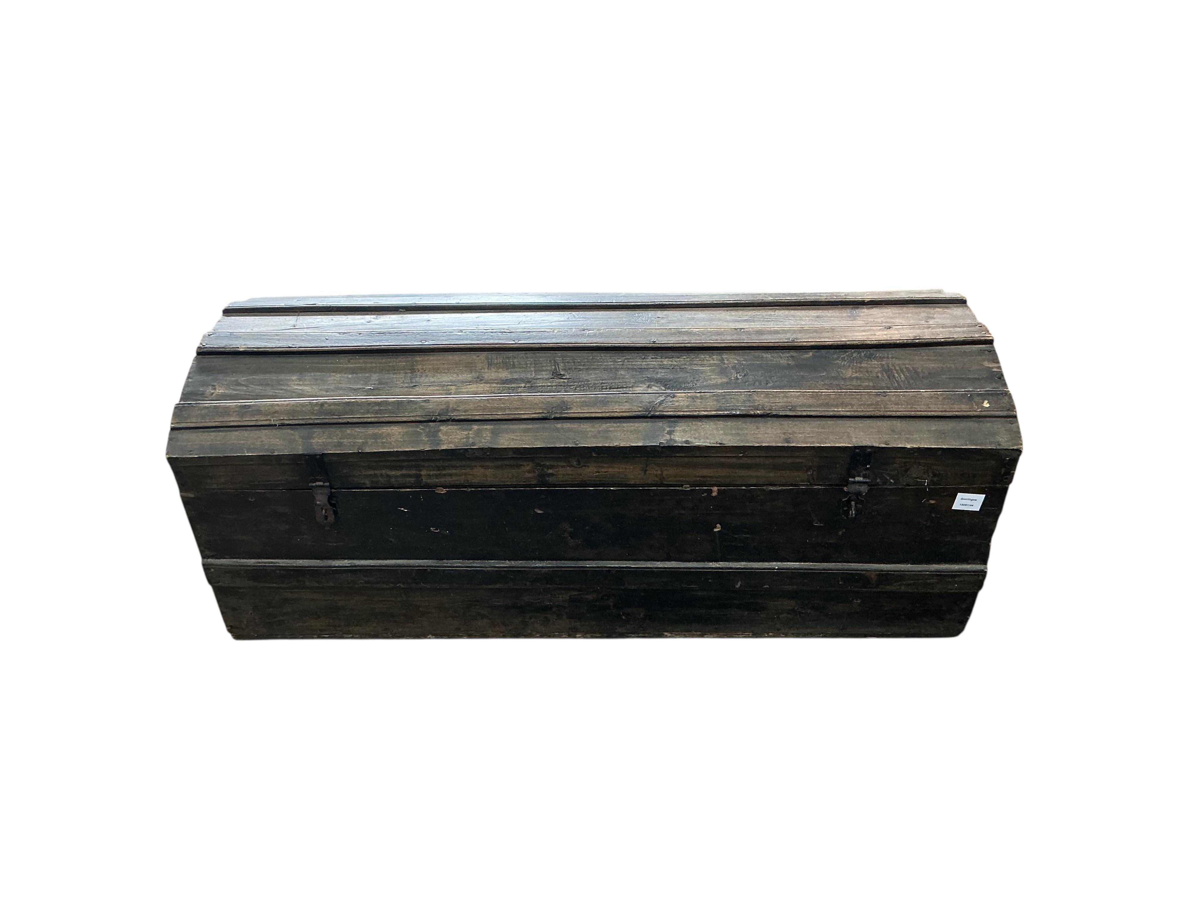 A stained pine domed top trunk, width 123cm, depth 46cm, height 47cm
